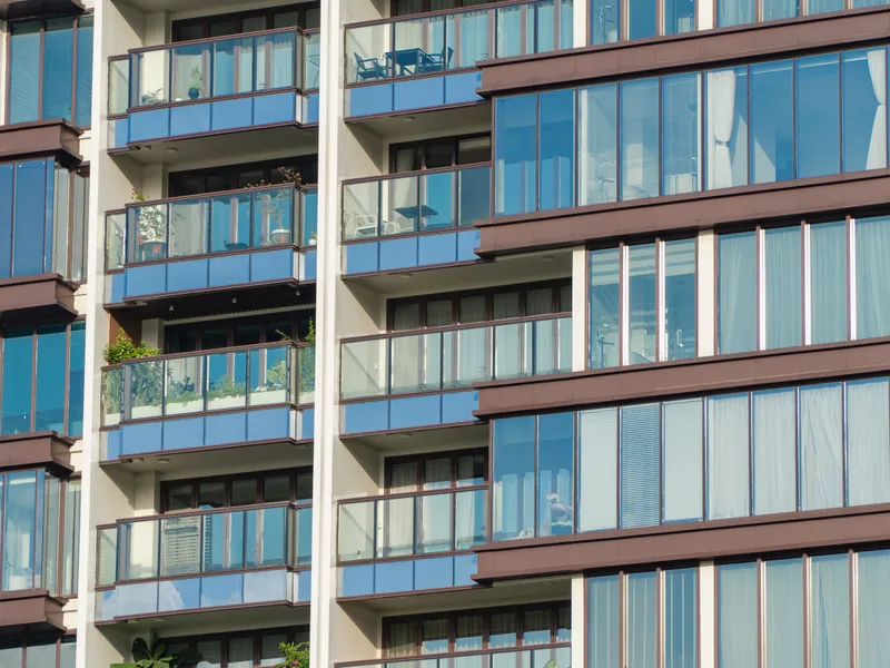 Glass balcony facade with curtained interiors, Texas real estate